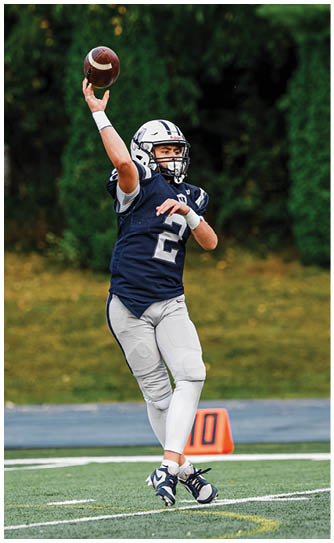 A football player catching a ball. Description generated by AI