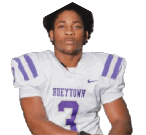 Person wearing a white football jersey with purple stripes and the word “HUEYTOWN" along with the number 3 on the front. Description generated by AI