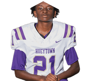 Person wearing a white and purple football jersey with the number 21 and the word Hueytown on the front. Description generated by AI
