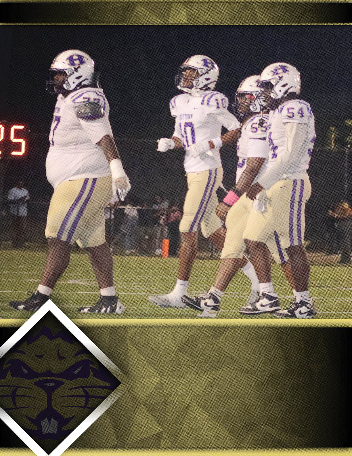 A group of people wearing purple and white football uniforms are gathered on a field with a logo of a wildcat in the corner. Description generated by AI