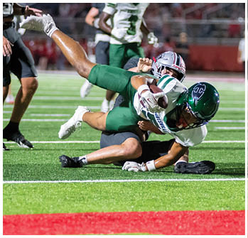 A football player running on the field. Description generated by AI