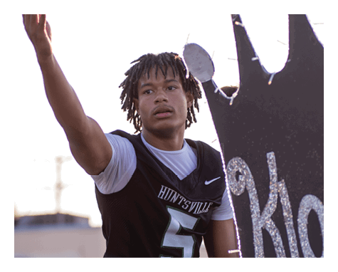 A man wearing a football uniform is jumping to catch a football. AI generated content