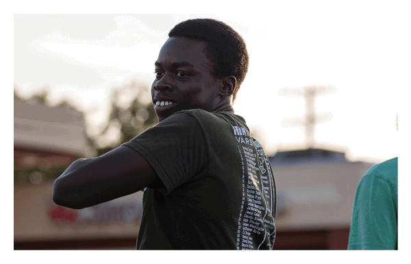 A group of football players wearing headphones and smiling. AI generated content