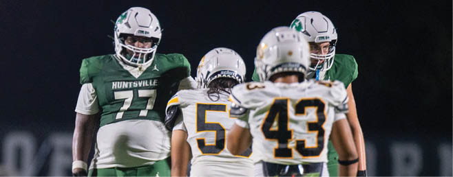 A group of football players in black and white uniforms are on the field. AI generated content