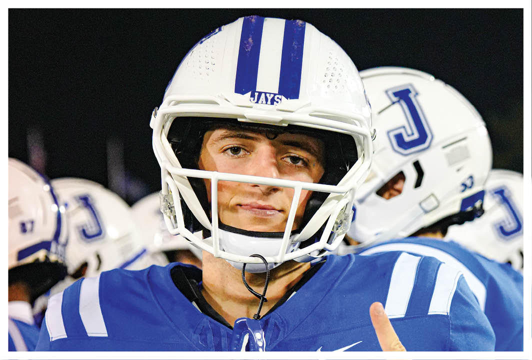 A football player wearing a blue and white jersey with the number 14 on it. AI generated content