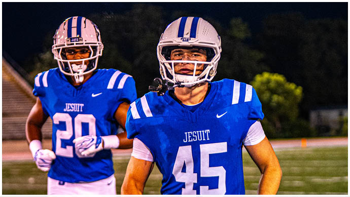 A football player wearing a blue and white uniform. Description generated by AI