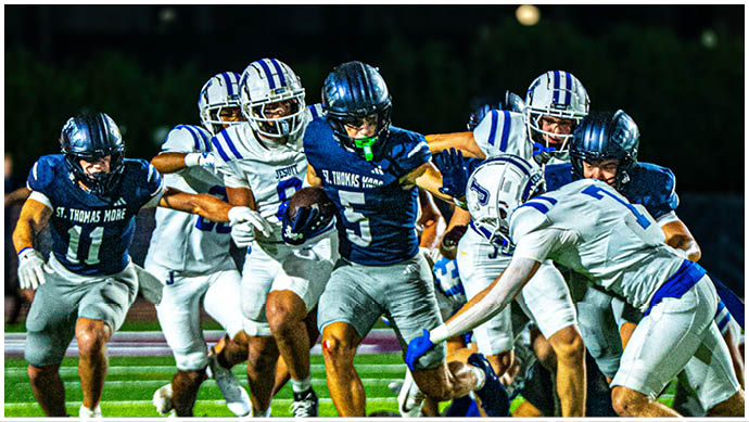 A football player wearing a blue and white uniform. Description generated by AI