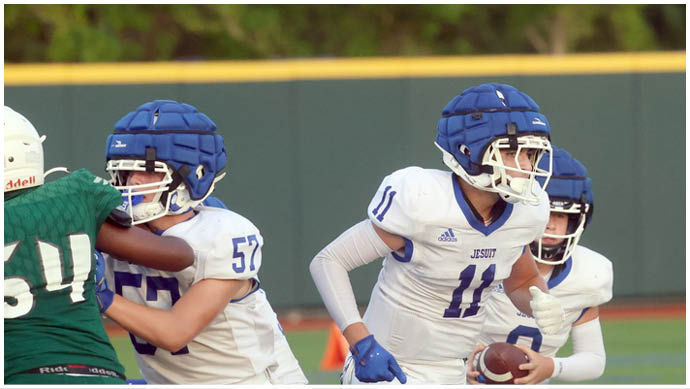 A football player wearing a blue and white uniform. Description generated by AI