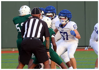 A group of football players on a field. Description generated by AI