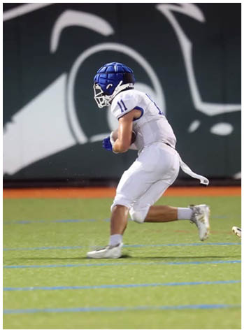 A football game is being played on a field. Description generated by AI