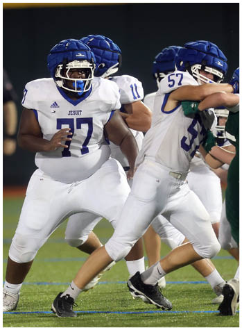 A football game is being played on a field. Description generated by AI