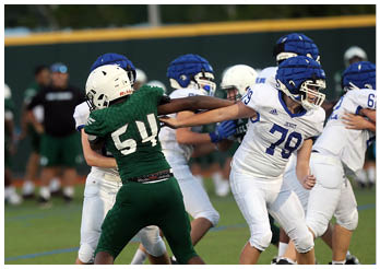 A group of football players on a field. Description generated by AI