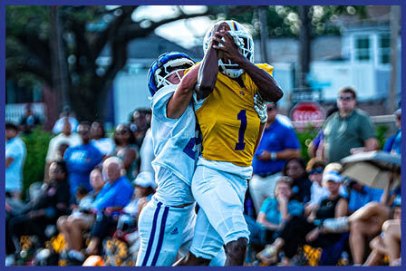 A football player catching a ball. Description generated by AI