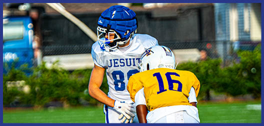 A football player wearing a blue and white uniform. Description generated by AI
