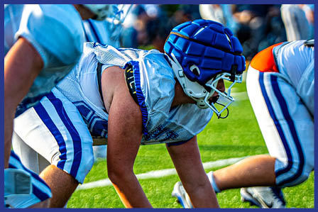 A football player catching a ball. Description generated by AI