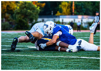 A group of football players on a field. Description generated by AI