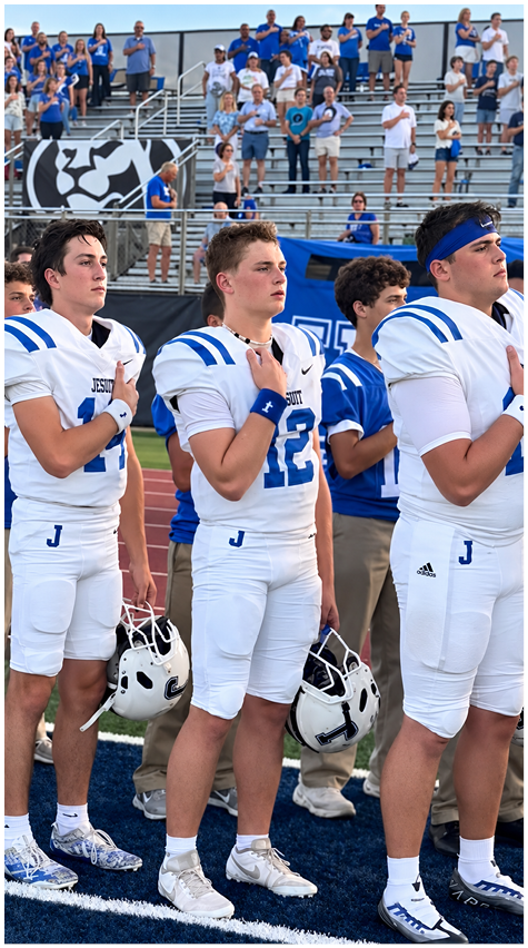 A group of football players on a field. Description generated by AI