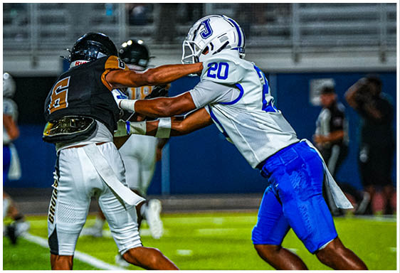A football player wearing a blue and white uniform. Description generated by AI