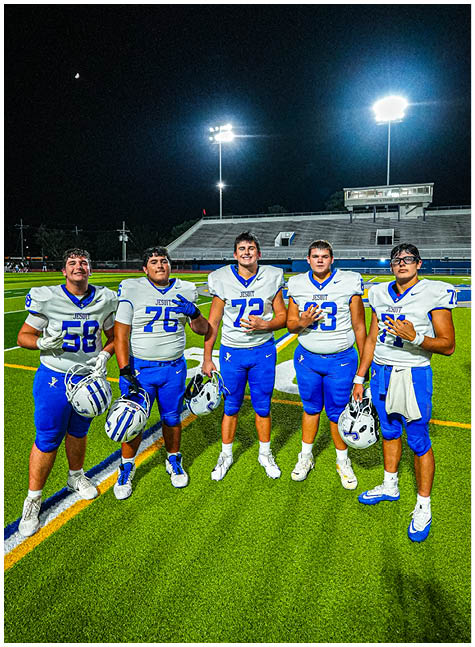 A group of football players on a field. Description generated by AI