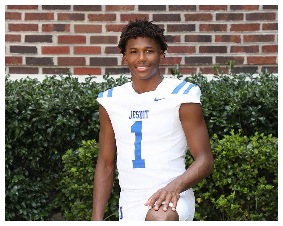 A football player wearing a blue and red jersey. Description generated by AI