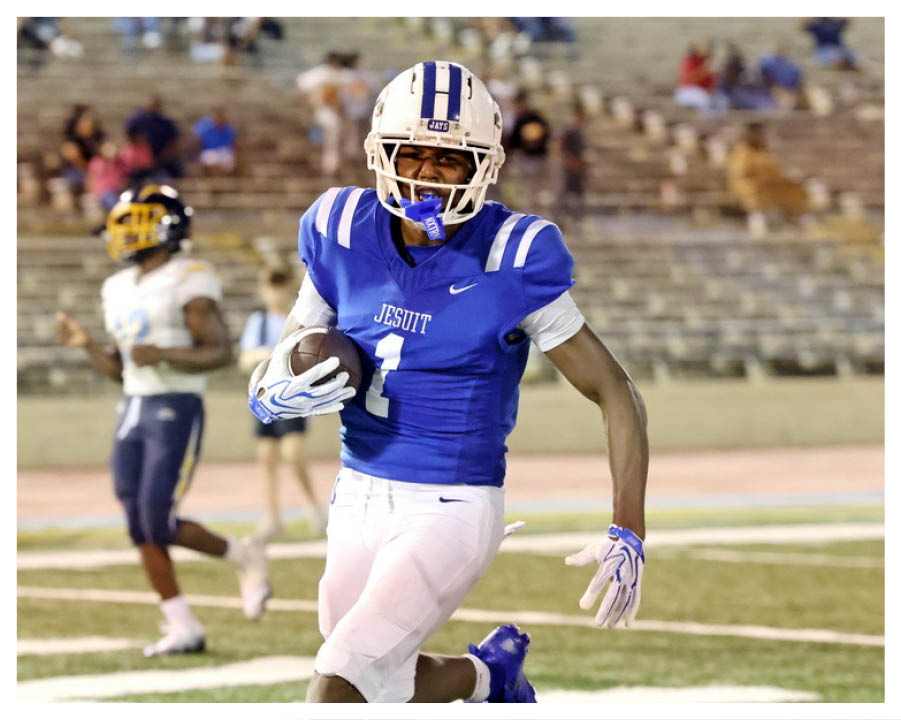 A football player wearing a blue and red jersey. Description generated by AI
