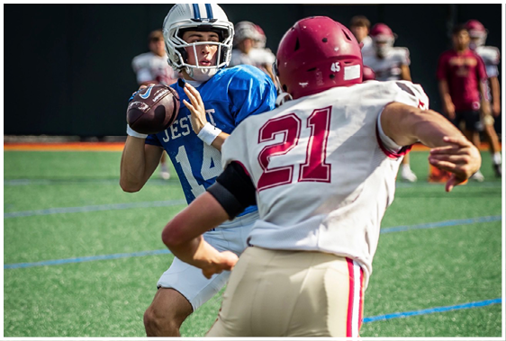 A football player wearing a blue and white uniform. Description generated by AI