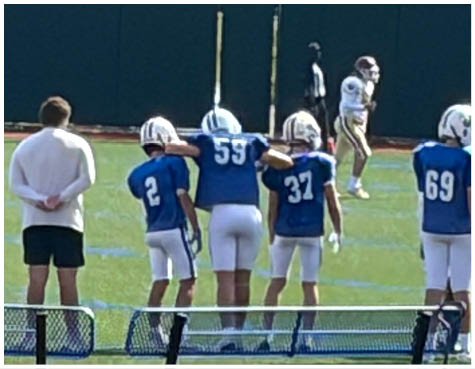A group of football players on a field. Description generated by AI