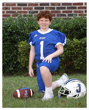 A football player wearing a blue and red jersey. Description generated by AI