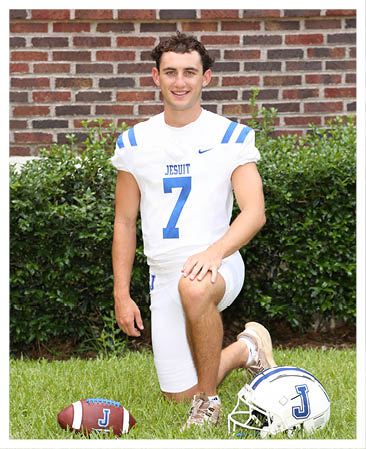 A football player wearing a blue and red jersey. Description generated by AI