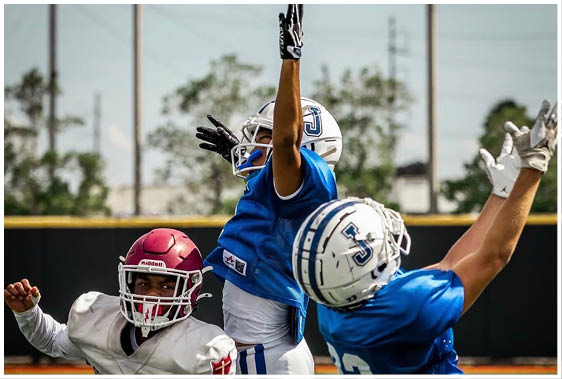 A football player wearing a blue and white uniform. Description generated by AI