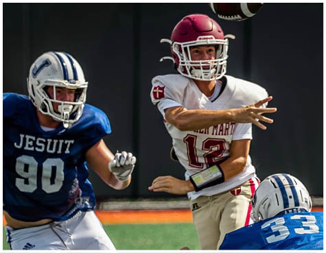 A group of football players on a field. Description generated by AI