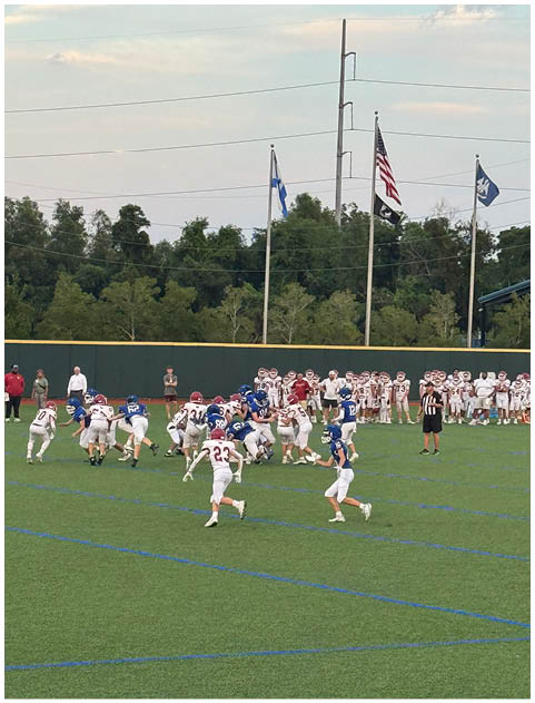A football game is being played on a field. Description generated by AI