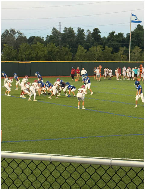 A football game is being played on a field. Description generated by AI