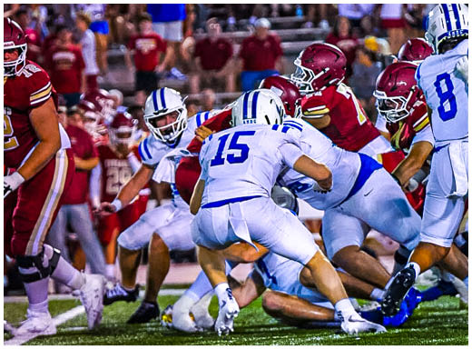 A football player wearing a blue and white uniform. Description generated by AI