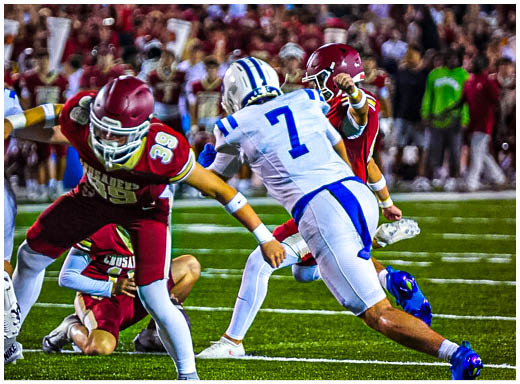 A football player wearing a blue and white uniform. Description generated by AI