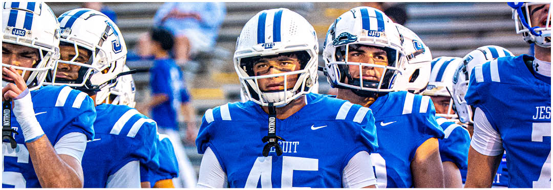 A football player wearing a blue and white uniform. Description generated by AI