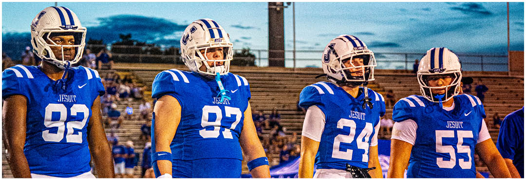 A football player wearing a blue and white uniform. Description generated by AI