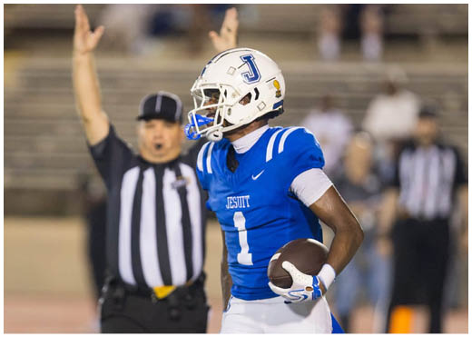 A football player wearing a blue and white uniform. Description generated by AI