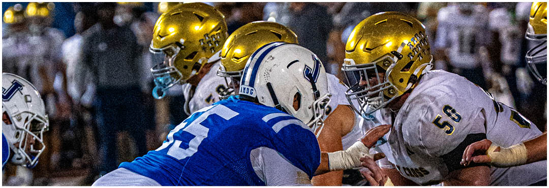 A football player wearing a blue and white uniform. Description generated by AI