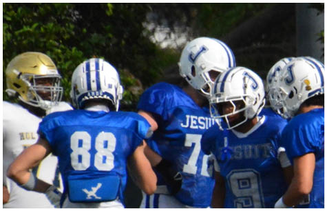 A group of football players on a field. Description generated by AI