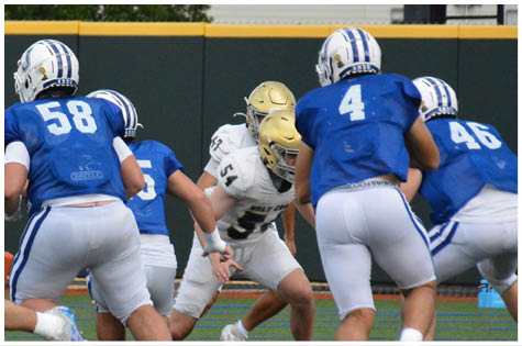 A group of football players on a field. Description generated by AI