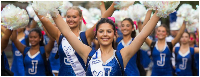 A football player wearing a blue and white uniform. Description generated by AI