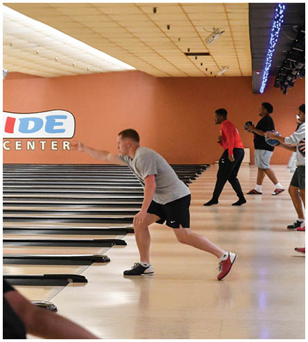 A group of people are playing bowling at a recreation center. Description generated by AI