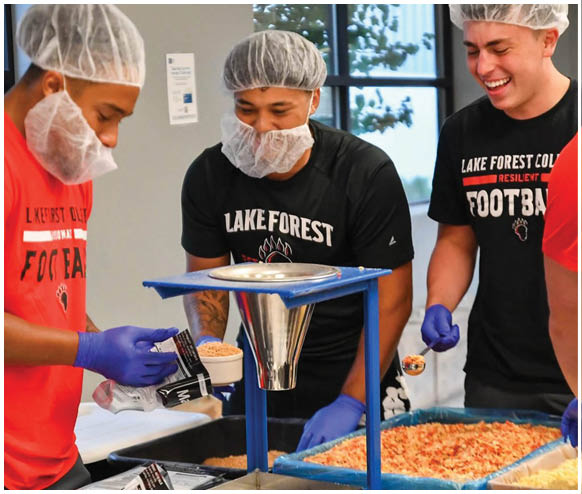 A group of people wearing hairnets and gloves are preparing food. Description generated by AI