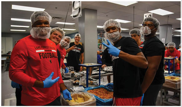 A group of people wearing masks and gloves. Description generated by AI