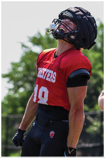 A man wearing a black and red jersey with the number 19 on it. Description generated by AI
