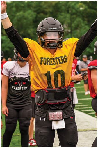 A football player wearing a yellow jersey with the number 10 on it. Description generated by AI