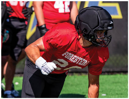 A football player wearing a red jersey with the number 33. Description generated by AI