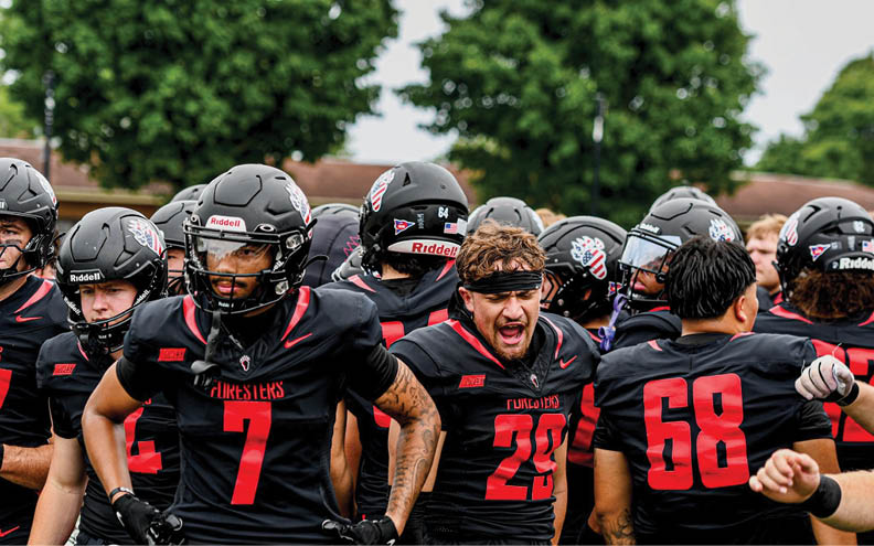 A group of football players wearing black jerseys with the number 7. Description generated by AI