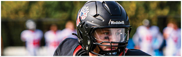 A football player wearing a black jersey with the number 10 on it. Description generated by AI